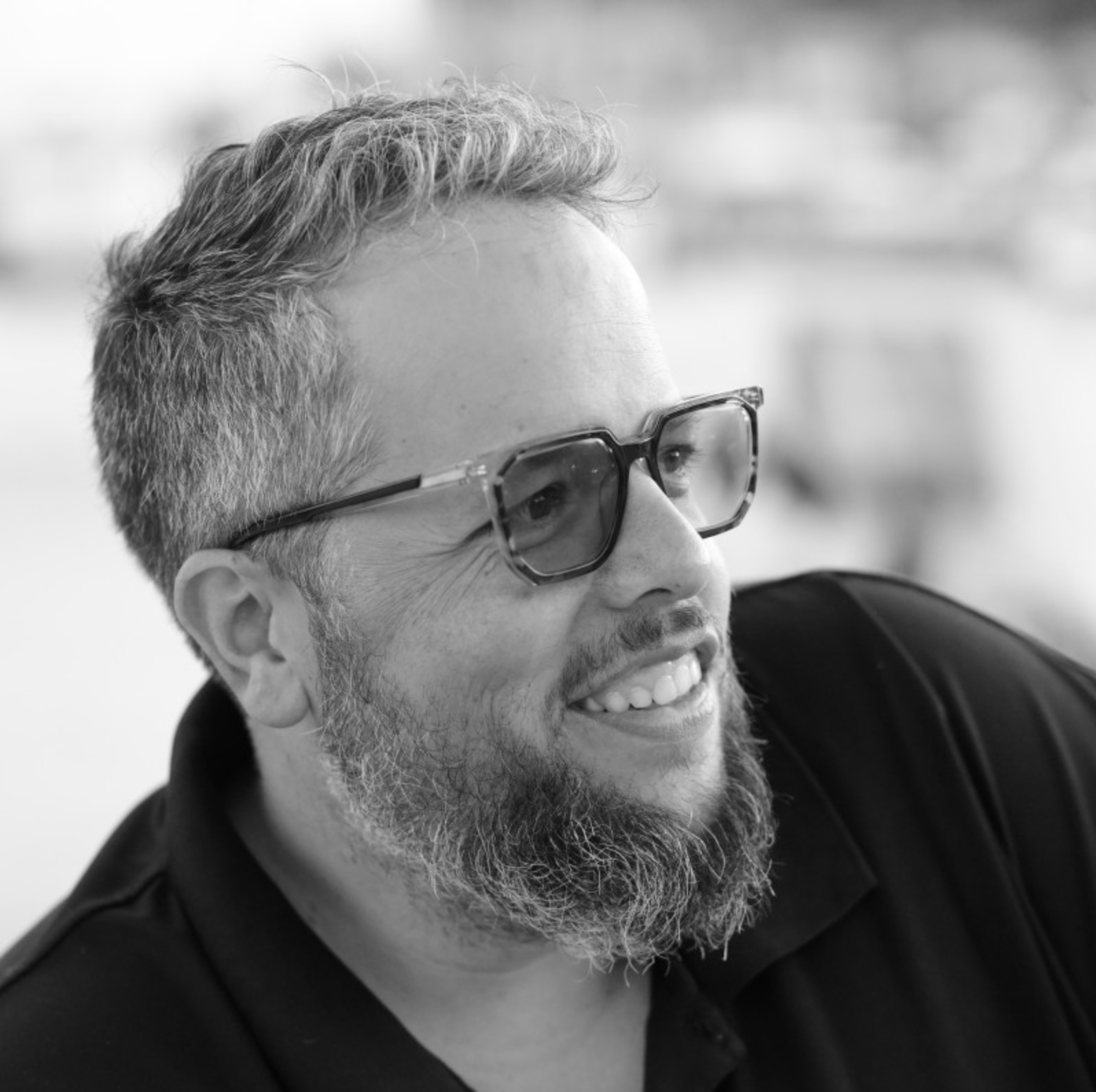 Black and White photo of Jesse Friedman with glasses and beard outdoors.