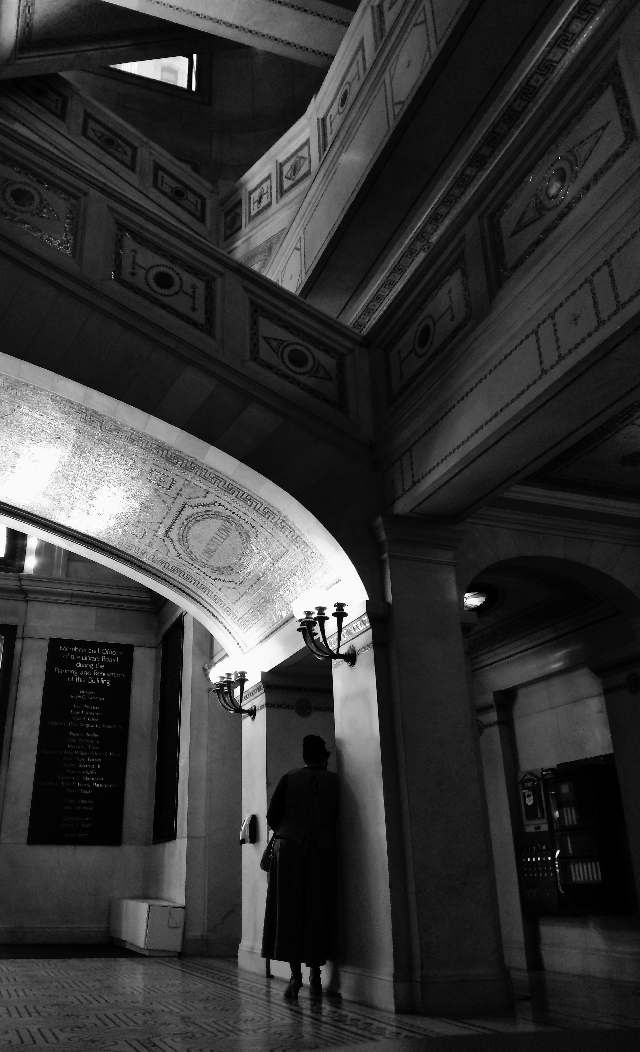 Black and White Photo of a woman standing in the Chicago Cultural Center